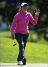  ?? ADRIAN WYLD — THE ASSOCIATED PRESS ?? First-round leader Marina Alex waves to the gallery on the eighth hole in the first round of the Canadian Pacific Women’s Open in Ottawa on Thursday.