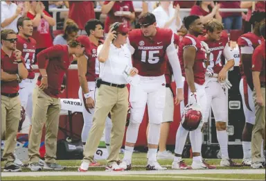  ?? NWA Democrat-Gazette/Charlie Kaijo ?? BIG TALK: Arkansas head football coach Chad Morris talks to quarterbac­k Cole Kelley (15) between plays Saturday during the first quarter of the Razorbacks’ 44-17 loss to North Texas at Donald W. Reynolds Razorback Stadium in Fayettevil­le.