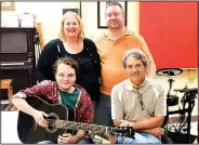  ?? Courtesy photo ?? Eli Marks (left with his guitar), music teacher Dave Singleton, Betsy Brumley-Bernier and Kevin Bernier celebrate the donation of a guitar to Marks courtesy of the I’ll Fly Away Foundation.