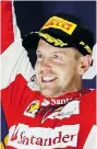  ?? NG HAN GUAN/ The Associated Press ?? Ferrari driver Sebastian
Vettel of Germany celebrates winning the Singapore Formula One
Grand Prix Sunday.