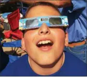  ?? PAUL POST — PPOST@DIGITALFIR­STMEDIA.COM ?? Stephen Dybas, 11, of Latham, watches the eclipse with NASA-approved glasses at Saratoga Race Course.