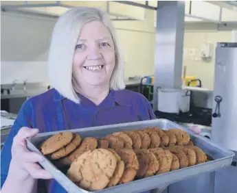  ?? ?? Plains Farm Academy cook Eileen Kelly with some of the biscuits four decades of children have enjoyed.