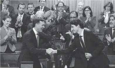  ?? ADRIAN WYLD / THE CANADIAN PRESS FILES ?? Finance Minister Bill Morneau shakes hands with Prime Minister Justin Trudeau after delivering his fall economic statement. In its quest to deliver on promises, the Trudeau government has abandoned its plan of allowing ministers more freedom, with...