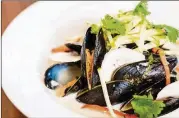  ?? CONTRIBUTE­D BY HENRI HOLLIS ?? The Alden serves steamed mussels in a fragrant pool of coconut-lemongrass nage, served with mushrooms, cilantro and Thai basil.