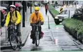  ?? NICK PROCAYLO/PNG FILES ?? Cyclists ride the Hornby St. bike lane during the morning rush hour in June 2012.