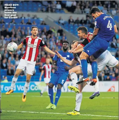  ?? Picture: PETER CZIBORRA ?? HEAD BOY: Morrison powers home the first goal for Cardiff