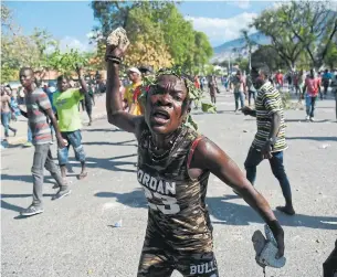  ?? HECTOR RETAMAL AFP/GETTY IMAGES ?? A group of tourists from Quebec plus a Canadian medical team are among those stuck in Haiti, unable to make it to the Port-au-Prince airport because of violent street protests.