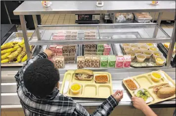 ?? ASSOCIATED PRESS ?? Department of Agricultur­e dollars cover the free and reduced-price school meal programs said to be the main source of nutrition for many students with little food at home. Georgia gets more than $758 million from the program.