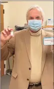  ??  ?? Darien Health Director David Knauf holds vaccines for COVID-19. He has been working with town and state leaders on the vaccine rollout.