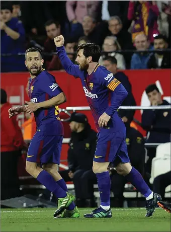  ??  ?? Lionel Messi celebrates after scoring a late equaliser for Barcelona against Sevilla.