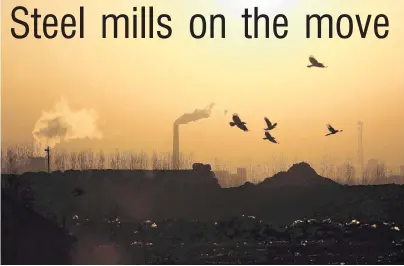  ?? PHOTOS: REUTERS ?? Flying the coop . . . Birds fly over a closed steel factory in Tangshan as the chimneys of a working factory smoke in the background.