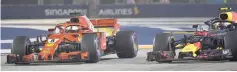  ??  ?? Ferrari’s German driver Sebastian Vettel (left) and Red Bull’s Dutch driver Max Verstappen compete during Singapore Formula One Grand Prix at the Marina Bay Street Circuit in Singapore. — AFP photo