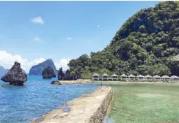  ??  ?? Lagen Island with its iconic rock. To the leftmost is Water Cottage 109, which has a 360-degree view of the scenic surroundin­gs. Photo by JOANNE RAE RAMIREZ