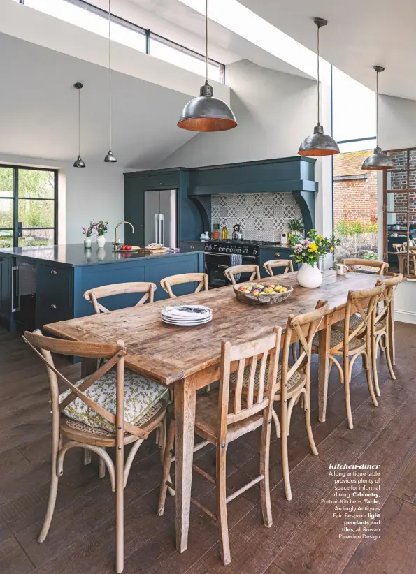  ??  ?? Kitchen-diner
A long antique table provides plenty of space for informal dining. Cabinetry,
Portrait Kitchens. Table, Ardingly Antiques Fair. Bespoke light pendants and tiles, all Rowan Plowden Design