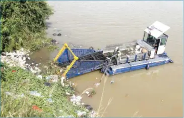  ?? HENG CHIVOAN ?? River Ocean Cleanup’s team uses German-sponsored boat to clean up Tonle Sap River in July.