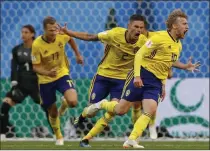  ?? Darko Bandic ?? Sweden’s Emil Forsberg, right, celebrates with teammates after scoring against Switzerlan­d on Monday in St. Petersburg, Russia.
The Associated Press
