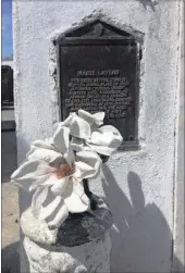  ??  ?? A plaque marks the tomb of “notorious voodoo queen” Marie Laveau.