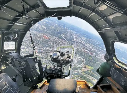  ?? Darrell Sapp/Post-Gazette ?? A view from the bombardier's position at the nose of the “Madras Maiden” B-17 flying over the South Hills on Monday, approachin­g Pittsburgh and Oakland. The Liberty Foundation's Boeing B-17 Flying Fortress, built near the end of WWII, is one of only 12...