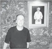  ?? COURTESY PALMA MARIA ?? Peter Rosinola Jr. at the Palma Maria’s “Tamaqua Table,” alongside a portrait of his father.