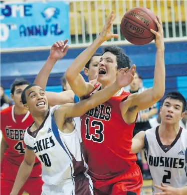  ?? Ed Kaiser/ ?? The Jasper Place Rebels’ Arran Chambers drives to the basket against Sturgeon Heights Huskies’ Nick Fletcher in the senior boys’ final of the Totem Hoop Classic at Ross Sheppard High School.