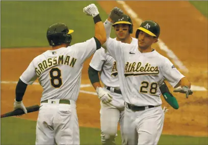  ?? ANDA CHU — BAY AREA NEWS GROUP, FILE ?? The A’s Matt Olson (28) celebrates with teammates Robbie Grossman (8) and Ramón Laureano (22) against the Astros on Sept. 10.