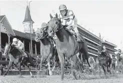  ?? DARRON CUMMINGS/ASSOCIATED PRESS ?? Joel Rosario rides Accelerate to victory in the Breeders' Cup Classic at Churchill Downs, holding off Gunnevera in the stretch.