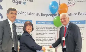  ??  ?? David Rutley MP, Councillor Janet Clowes from Cheshire East Council, and Mike Strutt, Age UK Cheshire East’s Chair of Trustees cut the celebrator­y anniversar­y cake