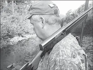  ?? Arkansas Democrat-Gazette/BRYAN HENDRICKS ?? Joe Volpe of Little Rock scans the trees for squirrels last Sunday in the Hurricane Creek Wilderness Area in Newton County. He uses a vintage Remington Model 11 20-gauge with a Poly-Choke.