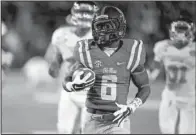  ?? AP/ROGELIO V. SOLIS ?? Mississipp­i running back Jaylen Walton (6) runs past a number of Mississipp­i State defenders for a 91-yard touchdown in the third quarter of the Rebels’ 31-17 upset victory.