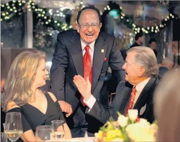  ?? Katie Falkenberg Los Angeles Times ?? USC PRESIDENT C.L. Max Nikias, center, with TV personalit­y Mary Hart and her husband, producer Burt Sugarman, at a donor dinner in 2011. In 2017, Nikias met his goal to raise $6 billion with months to spare.