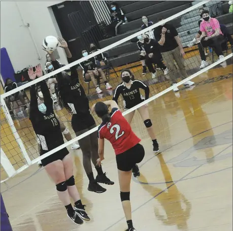  ?? File photo ?? St. Raphael setter Maddie Nault, left, and junior middle hitter Victoria Adegboeyga, middle, helped the Saints secure the No. 1 seed in the Division III playoffs with a sweep of second-place Rogers Tuesday afternoon at Alumni Hall.