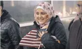  ?? SCOTT OLSON, GETTY IMAGES ?? Syrian refugee Baraa Haj Khalaf clutches an American flag after arriving with her family in Chicago on Feb. 7.