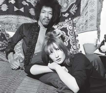  ?? GETTY IMAGES ?? American singer and guitarist Jimi Hendrix with girlfriend Kathy Etchingham in his Mayfair flat, London, in 1969. Scientists say it is an urban myth that his released pets started the British parakeet population.