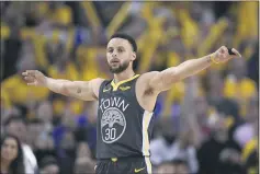 ?? JOSE CARLOS FAJARDO — BAY AREA NEWS GROUP, FILE ?? The Warriors’ Stephen
Curry spreads his arms up after a made basket by Klay Thompson during Game 2of the 2019 Western Conference Finals against the Trail Blazers.