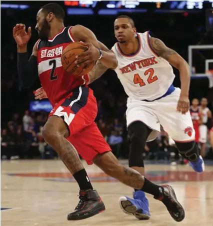  ?? Kathy Willens / Associated Press ?? Washington Wizards point guard John Wall (2) is among the top tier of players at his position, but the packed field means he gets lost among the greats.