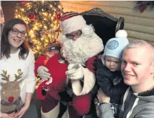  ??  ?? Two-day-old baby Michael, from Ballygowan, meets Santa at Hillmount with mum Lara, dad Jonny and sister Anna (2)