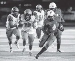  ?? AL DIAZ adiaz@miamiheral­d.com ?? Central running back Amari Daniels looks for more yardage as he’s pursued by Lely defenders on Saturday night at at Traz Powell Stadium in Miami.