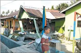  ?? DISASTER MANAGEMENT AGENCY/AP ?? Houses were damaged in at least two Indonesian cities after powerful earthquake­s and a tsunami jolted the island of Sulawesi on Friday. The tsunami hit Palu and Donggala.