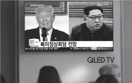 ?? ASSOCIATED PRESS ?? In this May 11, 2018 file photo, people watch a TV screen showing file footage of US President Donald Trump, left, and North Korean leader Kim Jong Un, right, during a news program at the Seoul Railway Station in South Korea.