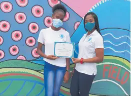  ?? JIS ?? ID Pioneers founder Leiseth Chambers (right) presents a certificat­e to former ward of the state, Newtana Jackson.