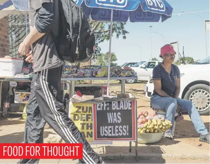  ?? Picture: Neil McCartney ?? Phindile Mkhonto sits at her stall outside the Protea North Magistrate’s Court in Soweto, Johannesbu­rg, yesterday.