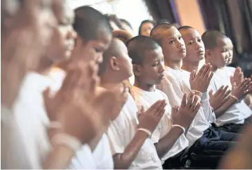  ??  ?? GOING BACK HOME: Members of the ‘Wild Boars’ team pray during a ceremony to mark their leaving the novitiate.