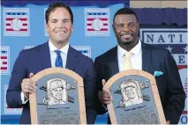  ?? McISAAC/GETTY IMAGES JIM ?? Mike Piazza, left, and Ken Griffey Jr. pose with their plaques after the Baseball Hall of Fame induction ceremony on Sunday in Cooperstow­n.