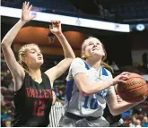  ?? CLOE POISSON/SPECIAL TO THE COURANT ?? East Hampton’s Delaney Russell shoots while guarded by Valley Regional’s Lily Grow in the first half of the Class M championsh­ip game at Mohegan Sun Arena in Uncasville on Saturday.