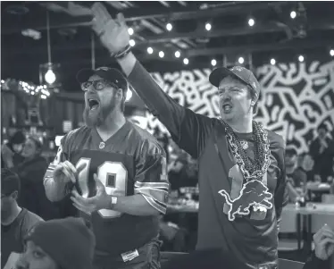  ?? DAVID RODRIGUEZ MUNOZ/ DETROIT FREE PRESS ?? Eric Henry, left, celebrates a Lions run next to his friend Josh Palmer at Batch Brewing Company in Detroit during Sunday’s NFC championsh­ip game against the 49ers in California.