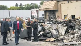  ?? EVAN VUCCI — THE ASSOCIATED PRESS ?? President Donald Trump walks Sept. 1, as he tours an area damaged during demonstrat­ions after a police officer shot Jacob Blake in Kenosha, Wis. At left is Attorney General William Barr and acting Homeland Security Secretary Chad Wolf.