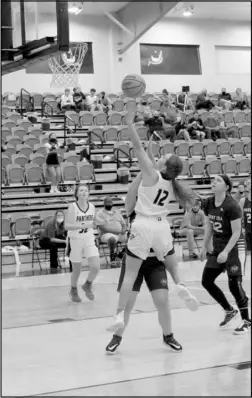  ?? Photo by Gerren Smith ?? STRONG FINISH AT THE BASKET: Magnet Cove Lady Panther hoopster Karsen Davis (12) drops a floater for a strong finish with the left hand to score against Mt. Ida in senior high girls basketball action. Davis led all scorer’s with a dandy 21 points in Magnet Cove’s season-opener victory against Mt. Ida 59-33.