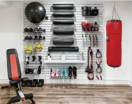  ?? Settled ?? Organize the items you use every day. The Gladiator slat wall keeps exercise equipment accessible and neat.