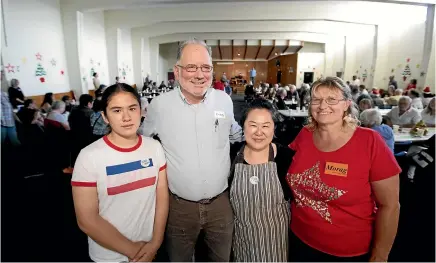  ??  ?? The Rollins family, from California, Helena, 13, left, Richard and Elaine with Community Christmas Lunch co-ordinator Morag Snelgrove ready to serve up some festive fare at St Joseph’s Church Hall yesterday.