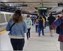  ?? ?? People walk from BART at the Embarcader­o BART Station in San Francisco during the morning commute on March 11.